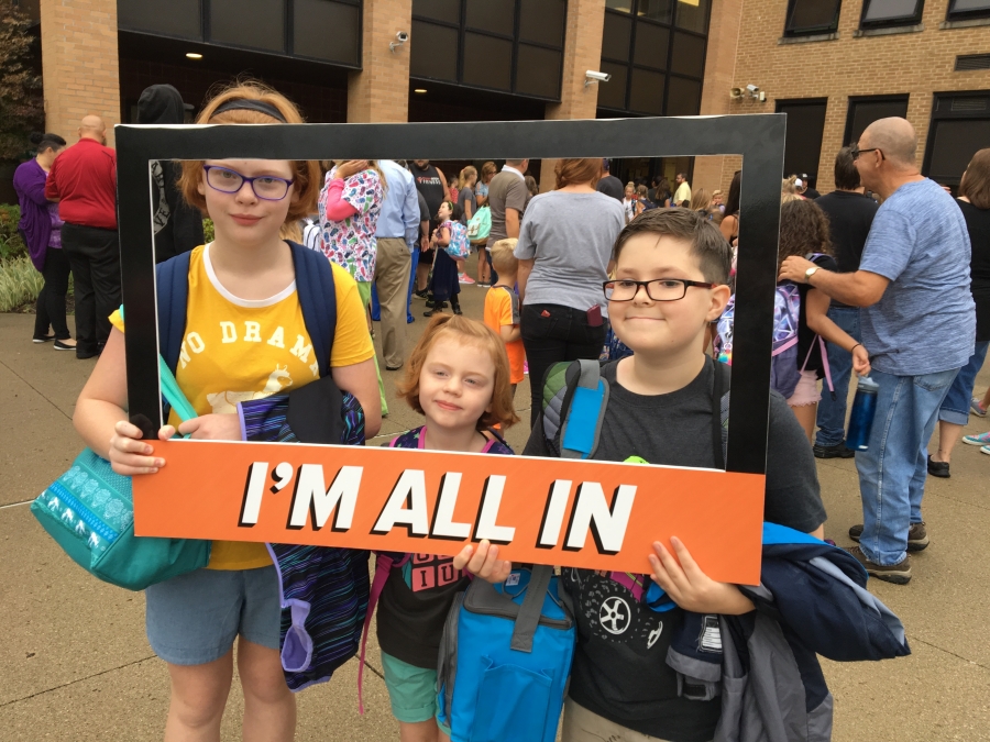 people holding a frame sign